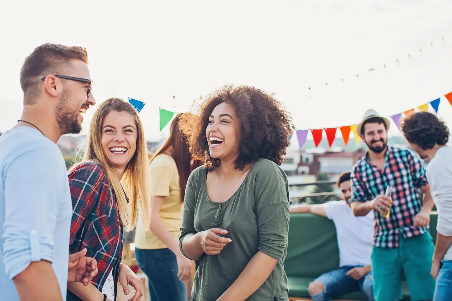 Friends smiling and laughing at an outdoor party