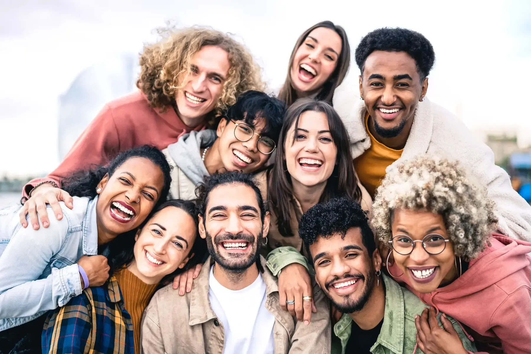 group of diverse young friends smiling and laughing